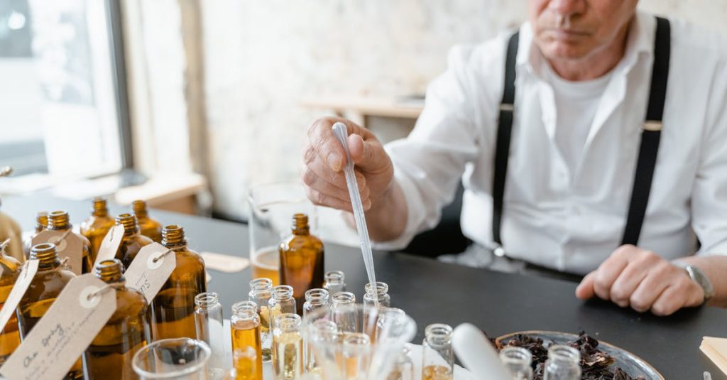 senior male preparing natural fragrance mixtures indoors using lab tools